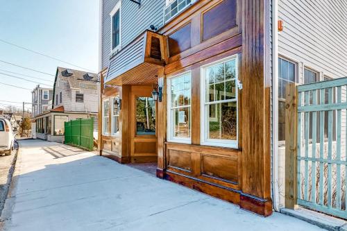 a house with a wooden door on a street at Two Neighboring Suites, Each w/ WiFi, Two TVs, and Central AC - Near Acadia in Northeast Harbor
