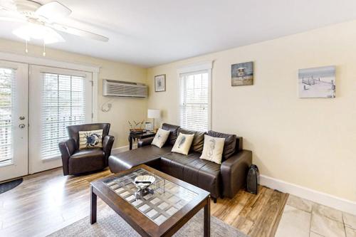 a living room with a couch and a table at Water-view condo at Sheepscot Harbour Resort with deck, full kitchen, and WiFi in Edgecomb