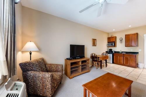 a living room with a couch and a tv at Lovely downtown Northeast Harbor suite near the water and near Acadia in Northeast Harbor