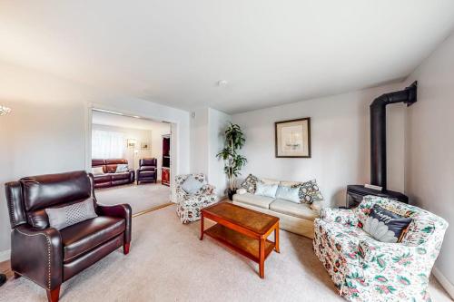 a living room with a couch and chairs at Idyllic waterfront home with furnished deck, grill, sweeping views & private W/D in Waldoboro