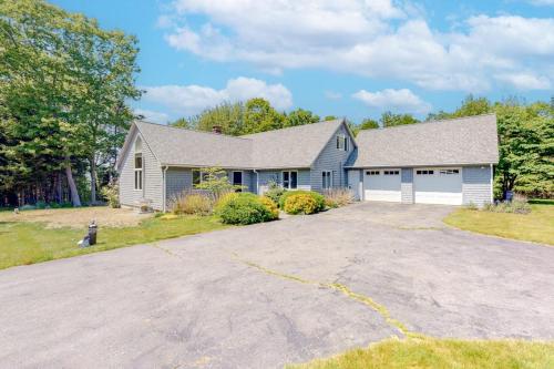 a house with a large driveway in front of it at Dog-friendly beach house with WiFi, private washer/dryer, deck, beautiful views in Bristol