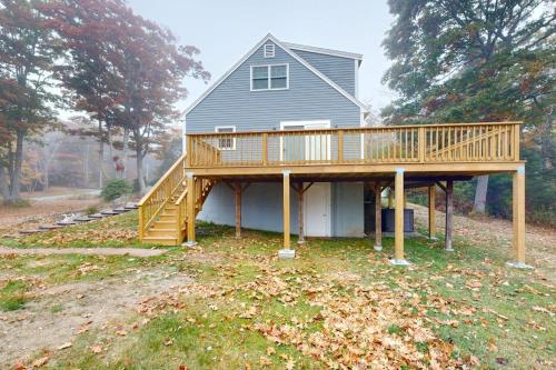 a house with a deck on the side of it at Boothbay Harbor Home with Water Views | Near Dining & Whale Watching in Boothbay Harbor