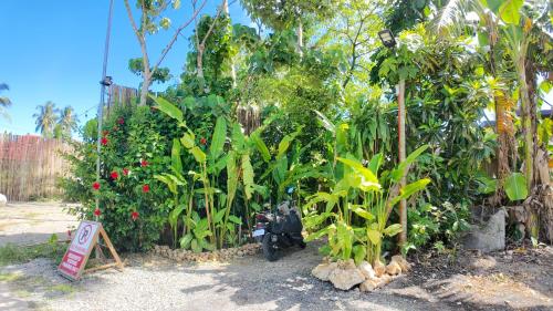 a motorcycle parked in front of a garden at Bom Dia Siargao Villas in General Luna