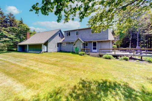 a home with a large yard with a house at Dog-friendly beach house with WiFi, private washer/dryer, deck, beautiful views in Bristol