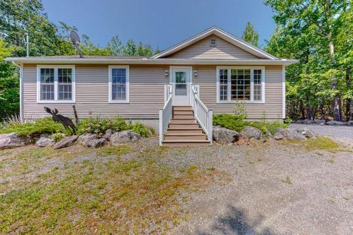 a small house with stairs in front of it at Inviting dog-friendly home with firepit & Ping-Pong - near Acadia National Park in Ellsworth
