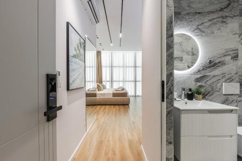 a bathroom with a sink and a mirror at Via Mare Jacuzzi Suites by PS in Durrës