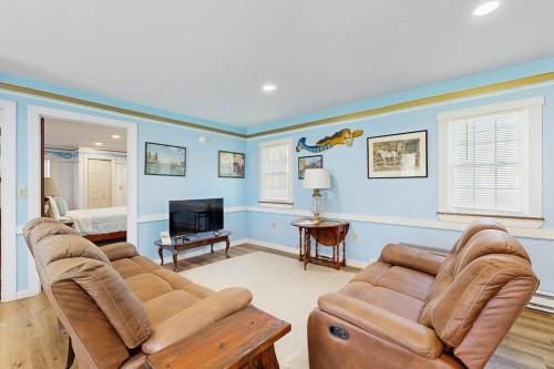a living room with a couch and a tv at Charming, single-level getaway with a full kitchen, fast WiFi, & grassy yard in Boothbay