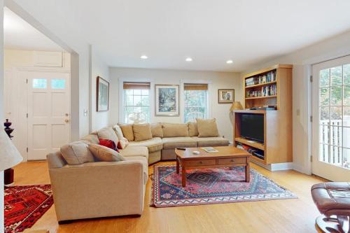 a living room with a couch and a tv at Gorgeous, walkable home with water view, deck & washer/dryer - snowbird-friendly in Camden