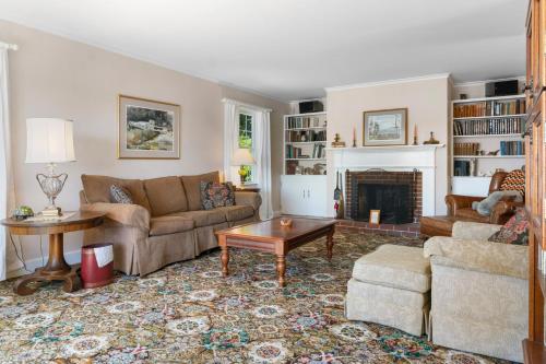 a living room with a couch and a fireplace at Dog-friendly oceanfront home with private shorefront, two fireplaces, & firepit in Steuben