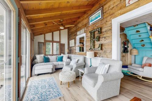 a living room with a couch and chairs and a table at Charming Oceanfront Home with Stunning Water Views and Wifi in Georgetown