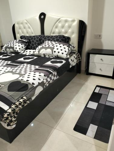a black and white bed with black and white pillows at Dani's Sea Breeze in Oran
