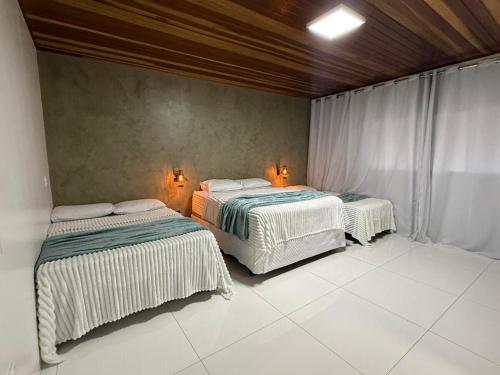 two beds sitting in a room with at Casa Pé da Serra in Estivado