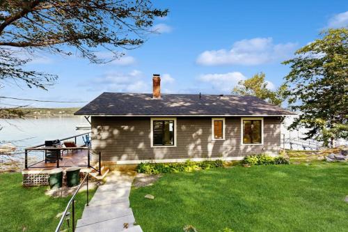a house on the shore of a lake at 2 Waterfront Cottages in Ocean Point with Dock & Large Yard, Dog friendly in East Boothbay