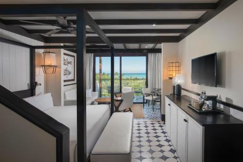 a hotel room with a bed and a view of the ocean at Ocean Riviera Paradise All Inclusive in Playa del Carmen
