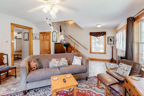 a living room with a couch and a table at Two-story home steps from Laite Beach - stroll to the harbor, 1 dog welcome in Camden