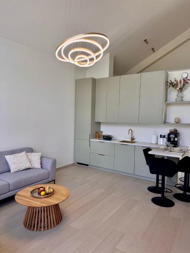 a kitchen and living room with a couch and a table at Järvemetsa Stay in Dejevo