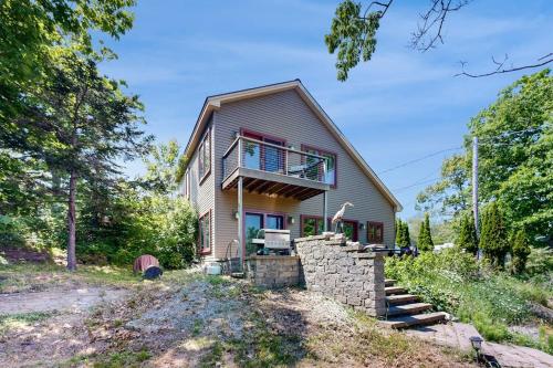 a house with a balcony on the side of it at Dog-friendly home with high-speed WiFi, washer/dryer, & private dock in Cundys Harbor