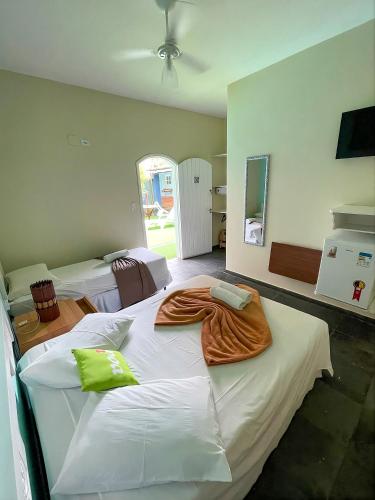 a large bed in a room with two beds at Pousada Morada do Tombo in Guarujá