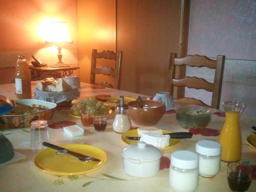 a table with plates and utensils on it at Le Point du Jour in Revin