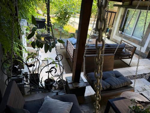 a porch with a swing and a patio with a swing at Къща за гости Mia Maria in Tutrakan
