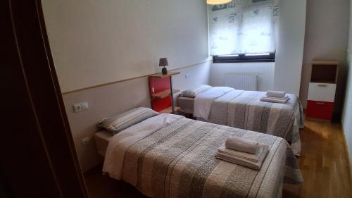 a room with three beds with towels on them at Ayalga2 in Villaviciosa