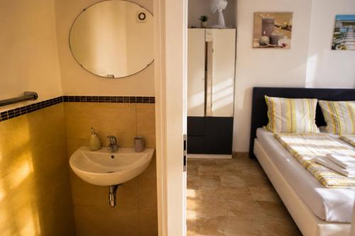 a bathroom with a sink and a mirror at Hotel Restaurant Neffelthal in Kerpen
