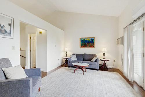 a living room with a couch and a table at Dog-Friendly Townhouse w/Bay Views, Fast WiFi, and Partial A/C in Bar Harbor