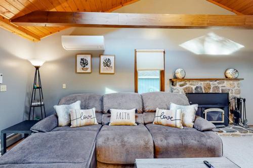 a living room with a couch and a fireplace at Tree-lined home with screened porch & perfect Midcoast location in Damariscotta