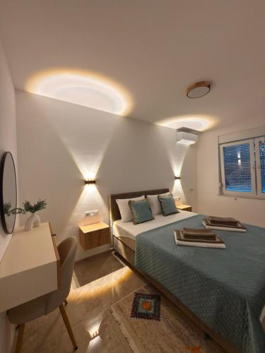 a bedroom with a bed and a table and a chair at Villa Una Bellevue in Bihać
