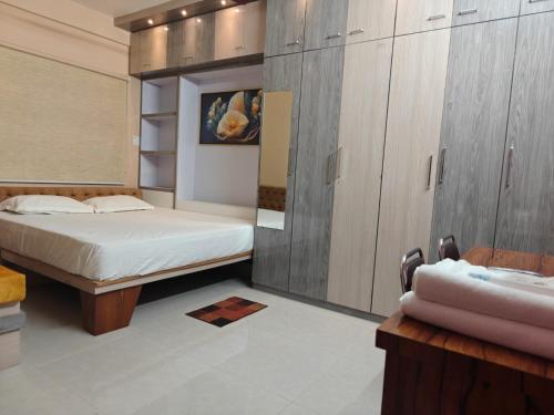 a bedroom with a bed and a sink at NHM Stays in Garui