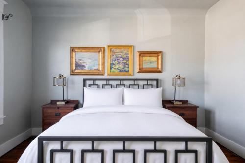 a bedroom with a white bed and two lamps at Robin's Egg, Private Downtown, Pet-Friendly Gem in Columbus