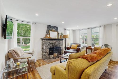 a living room with a couch and a fireplace at Coastal charmer with screened-in porch, grill, & AC in Boothbay Harbor