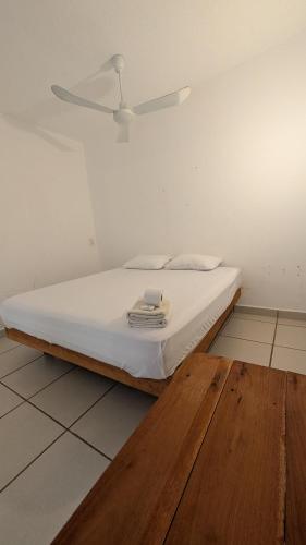 a white bed in a room with a ceiling at Aruma Stays in Brisas de Zicatela