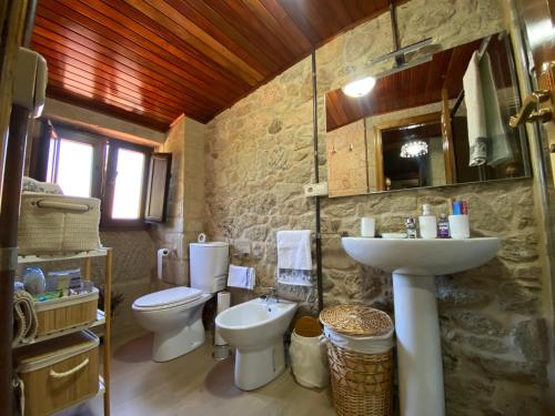 a bathroom with a toilet and a sink at Casa Do Conde in Caldas de Reis