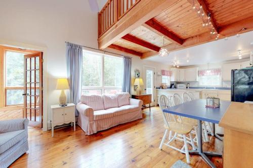 a kitchen and living room with a blue table and chairs at Home with deck, great location in the heart of Acadia National Park in Otter Creek