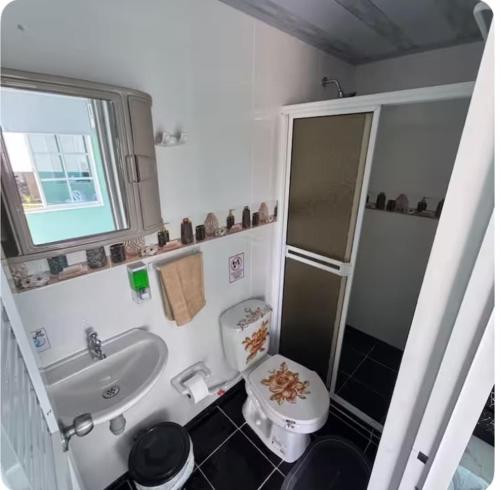 a small bathroom with a sink and a toilet at Posada MaiMai in Providencia