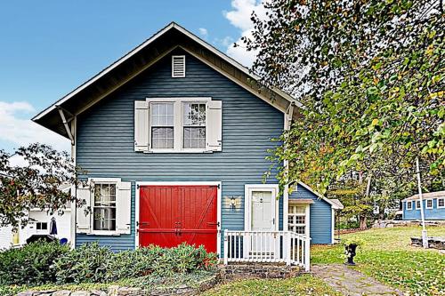 a blue and red house with a red garage at Historical New England home, outdoor shower , Dog-friendly in Boothbay Harbor