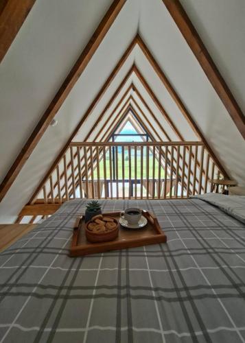 a table in the middle of a room in a attic at Ninina koliba-vikendica Manjaca in Hiseti