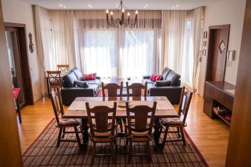 a dining room table and chairs in a living room at Transylvanian Villa in Predeal