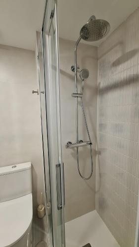 a bathroom with a shower with a glass door at Torre Mar Muchavista in El Campello