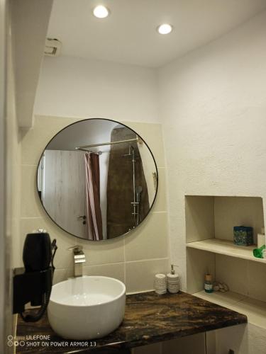a bathroom with a sink and a mirror at ''RENATA'' Studio in Kithnos