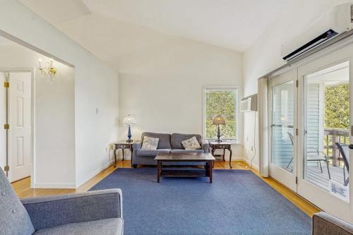 a living room with a couch and a table at Family & Dog-Friendly Townhouse w/Back Porch, Views, Partial AC in Bar Harbor