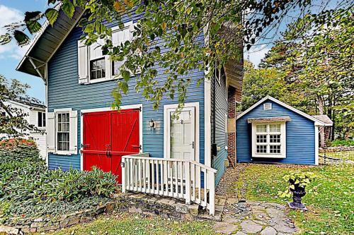 a blue and red house with a red garage at Historical New England home, outdoor shower , Dog-friendly in Boothbay Harbor
