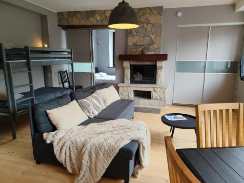 a living room with a couch and a fireplace at Turu 6, Quiet Central Apartment in Haapsalu