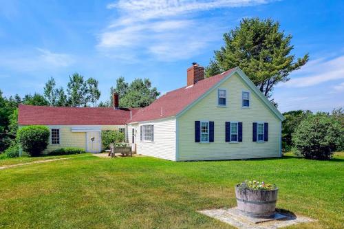 a white house with a red roof and a yard at Charming Seaside Cottage with a Gas Fireplace, Spacious Patio, and Nearby Hiking in Hancock