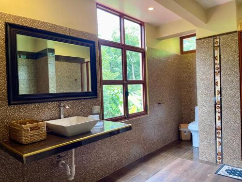 a bathroom with a sink and a mirror at MONTEVERDIA - Hotel & Resort in Pozuzo