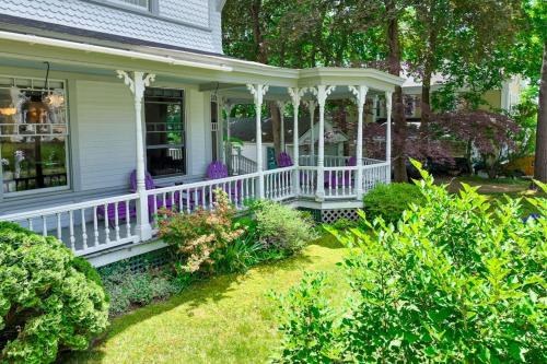 a white porch with white railings on a house at Beautiful home with Ping-Pong, fast WiFi & W/D - walk to dining in Wiscasset
