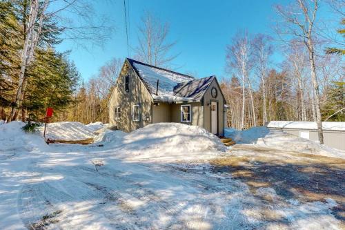 a house with snow in front of it at Cozy woodsy Cabin w/ a Deck, Firepit, Gas Grill, Free WiFi, & Full Kitchen in Greenville