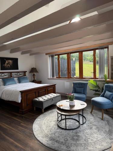 a bedroom with a bed and a table and chairs at Ben Wyvis View Annexe in Inverness