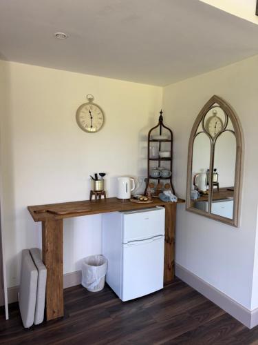 a kitchen with a counter and a clock on the wall at Ben Wyvis View Annexe in Inverness